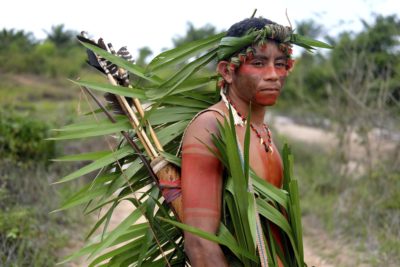 An Indigenous Tembe man on patrol in the forest at Brazil's Alto Rio Guama reserve.