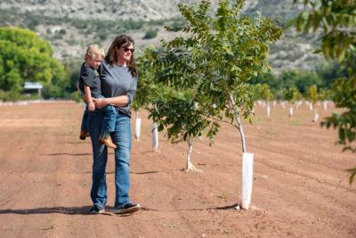 Claudia Hauser, with her son Cy, is among the farmers in Arizona’s Verde Valley working with The Nature Conservancy to deploy water-efficient irrigation systems and plant crops that use less water.