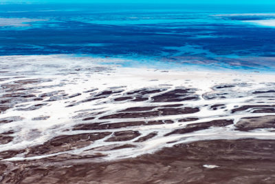 The Colorado River once flowed into the Gulf of California, but now its dried-up delta is a desiccated landscape of old river channels, salt tidal flats, and mineral deposits.