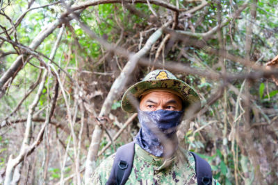 A Cambodian environmental ranger on patrol looking for illegal loggers in the Phnom Tnout Phnom Pok sanctuary. Some rangers hide their identity out of fear of reprisals from loggers and their allies in the police and military.