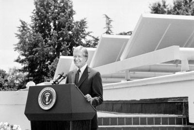 President Jimmy Carter in front of solar panels on the roof of the White House, June 20, 1979. 