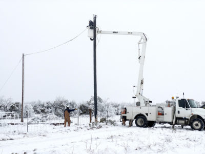 Workers attempt to restore power after a severe winter storm caused outages across Texas, February 2021.
