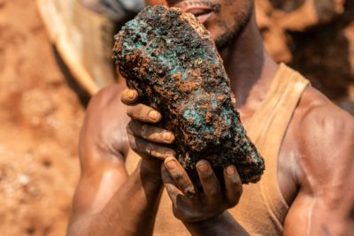 Dela wa Monga, an artisanal miner, holds up a cobalt stone.