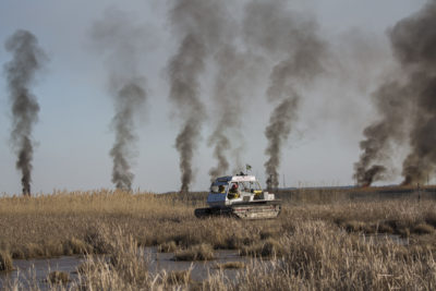 Officials observe a controlled burn on Jeff Kirwan's land near the Blackwater National Wildlife Refuge in February.