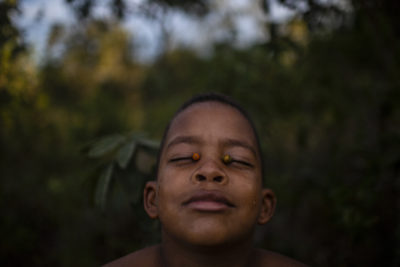 ​Joao Pedro, 10, plays with murici fruits in the village of Cacimbinha in western Bahia. The region is home to communities that date to the 19th century, when escaped plantation slaves and other immigrants intermarried with Indigenous people.