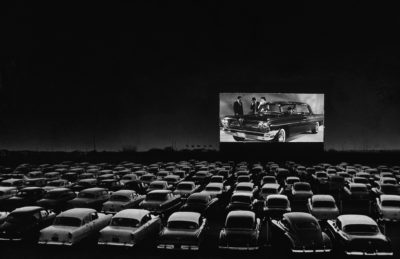 Cars fill a drive-in theater, 1950s. 