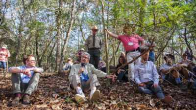 Conservationists and scientists, including biologist E.O. Wilson (center, with microphone), gathered in Torreya State Park this month to discuss strategies to save the beleaguered Florida torreya tree.