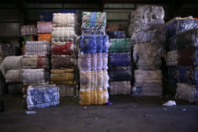 Piles of discarded textiles ready for recycling.
