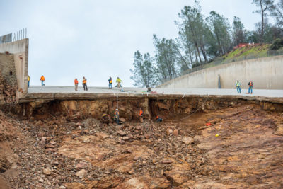 Workers assess damage following the collapse of a spillway at the 50-year-old Oroville Dam in California in 2017.