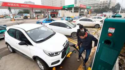 A driver charges his electric vehicle at a service station in Hangzhou in China's eastern Zhejiang province.