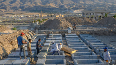 Workers transfer corpses to a cemetery in New Hasankeyf, a settlement outside the Ilisu Dam inundation zone. 