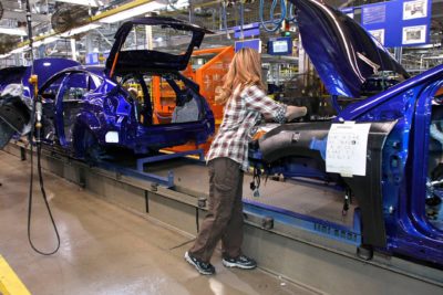 A worker builds a hybrid vehicle on the assembly line at Ford Motor Company's plant in Wayne, Michigan. 