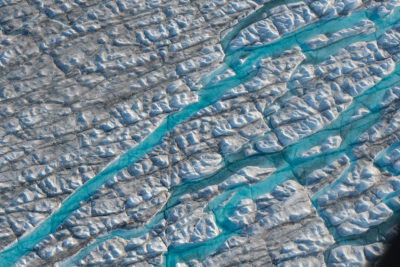 Meltwater carves a path through the Greenland ice sheet.