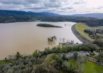 Lake Mendocino in October 2021 (left) amid a drought, and in January 2023 (right) following a series of major storms.