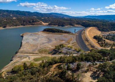 Lake Mendocino in October 2021 (left) amid a drought, and in January 2023 (right) following a series of major storms.