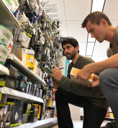 University of Michigan students Michael Reiner and Ben Stacey survey light bulb prices in a low-income neighborhood near Detroit.
