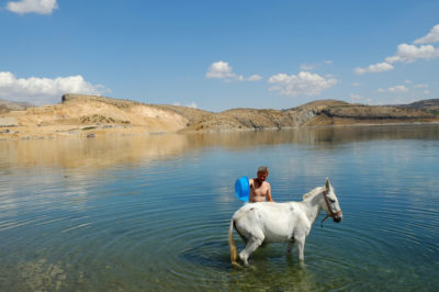 A man washes a horse at the Ataturk Dam reservoir on the Euphrates River.