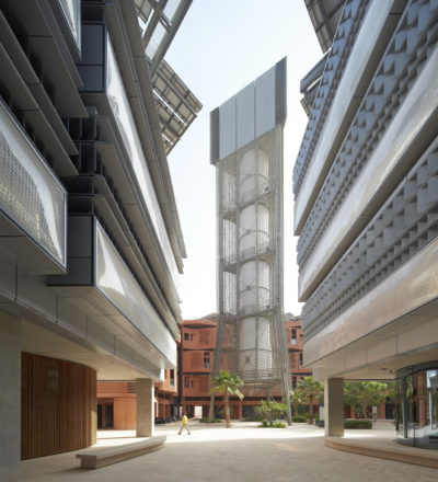 A street view in Masdar City, United Arab Emirates, showing a tower that circulates cooler air.