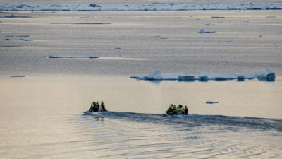 A film crew from the Oden explores Cunningham Inlet, which historically would have been blocked by sea ice in July. 