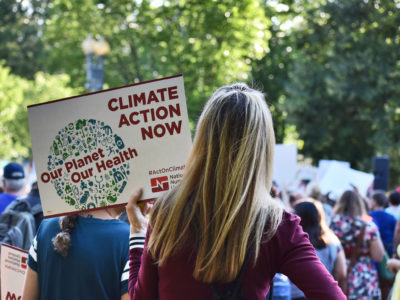 An activists calls for climate action at a Paris protest in 2017.