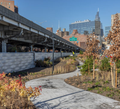 A park path runs along a floodwall on the east side of Manhattan. 
