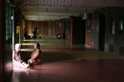 Two women in the communal area inside the Sungai Buri longhouse. 