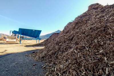 A worker manages a biomass-fed heat-power system in Quincy, California. The facility and several others managed by the Sierra Institute are powered using wood sourced from nearby forests.