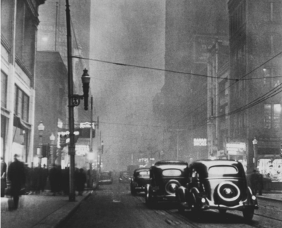 Pittsburgh shrouded in smoke at mid-day, circa 1940.