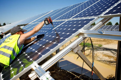 A technician installs solar panels in Bavaria, Germany.