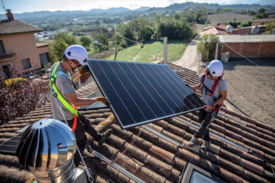Workers install a solar panel on a home in Barcelona, Spain, last September.