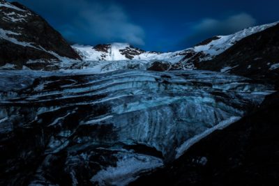 The Forni Glacier at night, with the ice reflecting the moonlight.