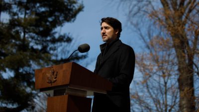 Prime Minister Justin Trudeau talking with reporters outside Rideau Cottage during his isolation in March.