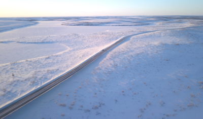 The Dempster Highway cuts across a desolate stretch of northern Canada. Remote villages are pushing to build another such road to ship in essential goods.