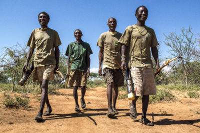 Two Hadza scouts joined by two elders on patrol.