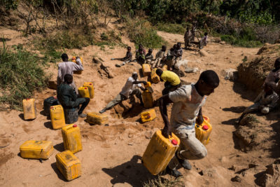 Locals in Adamawa, Nigeria dig into a dry riverbed to access water.