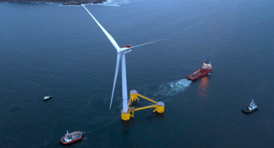 A floating turbine being pulled out to sea off the coast of Portugal for the WindFloat Atlantic project, now under construction.