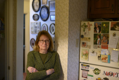Karen Gdula in her Center Township home, where she grew up. The walls are adorned with photos of her ancestors.