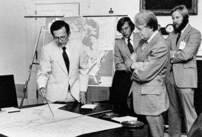 Carter reviews maps of Alaska with Senator Ted Stevens.