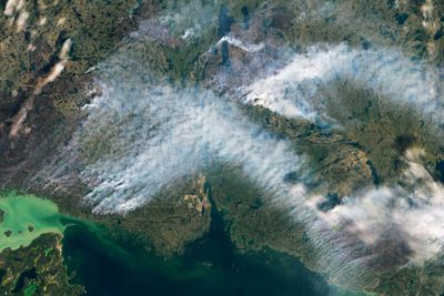 Smoke from wildfires in Canada's Northwest Territories in August. Burned woodlands are gray, while unburned woodlands are green. This year Canada endured its worst wildfire season on record, with flames scorching an area the size of Alabama.