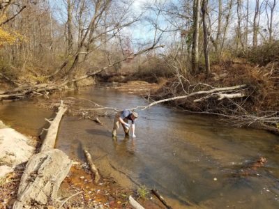 A riverkeeper samples water near a poultry farm in the Catawba River Basin.