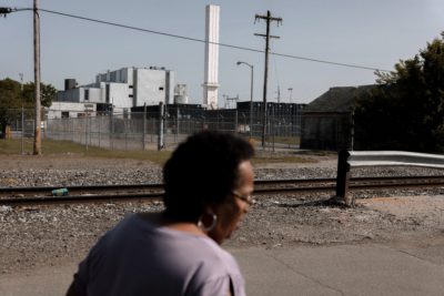 Zulene Mayfield walks on a residential street near the Covanta incineration facility in Chester, Pennsylvania.